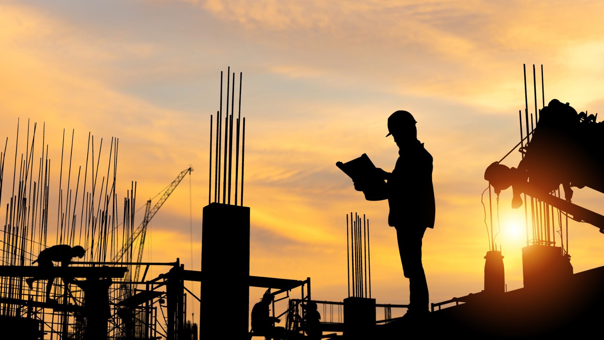 Silhouette of Engineer and workers checking project at building site